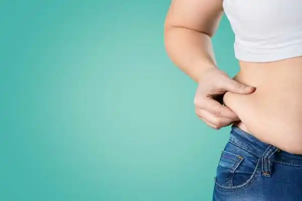 Image of woman pinching her love handles to show weight gain Eccleshill
